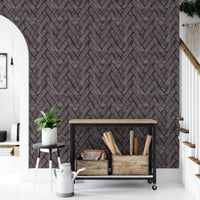 Entryway with dark brown brick wallpaper and a black console table near stairs.