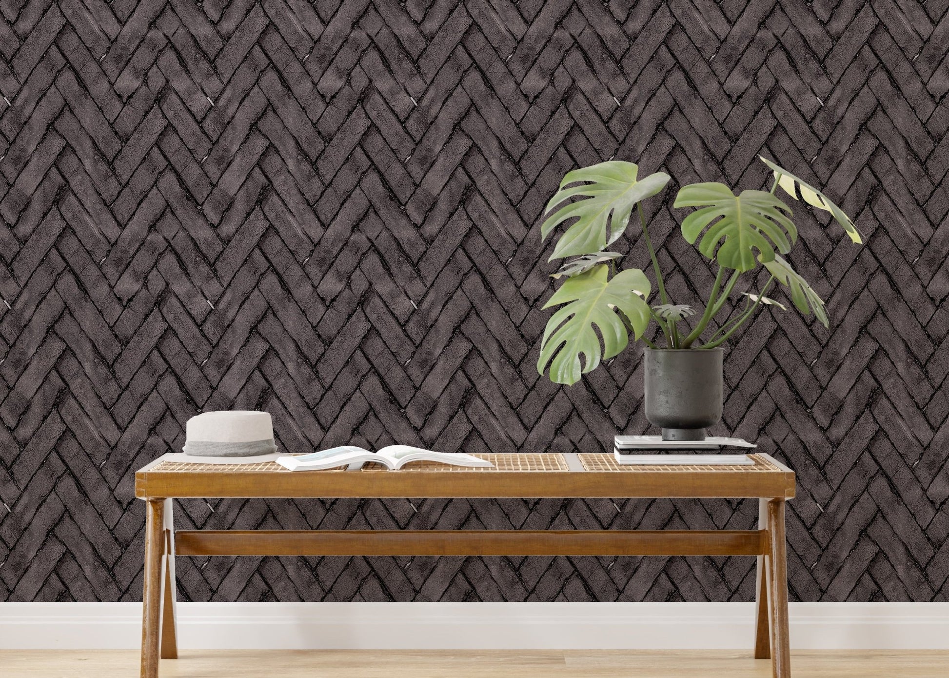 Living room accent wall with dark brown brick wallpaper and potted green plants.