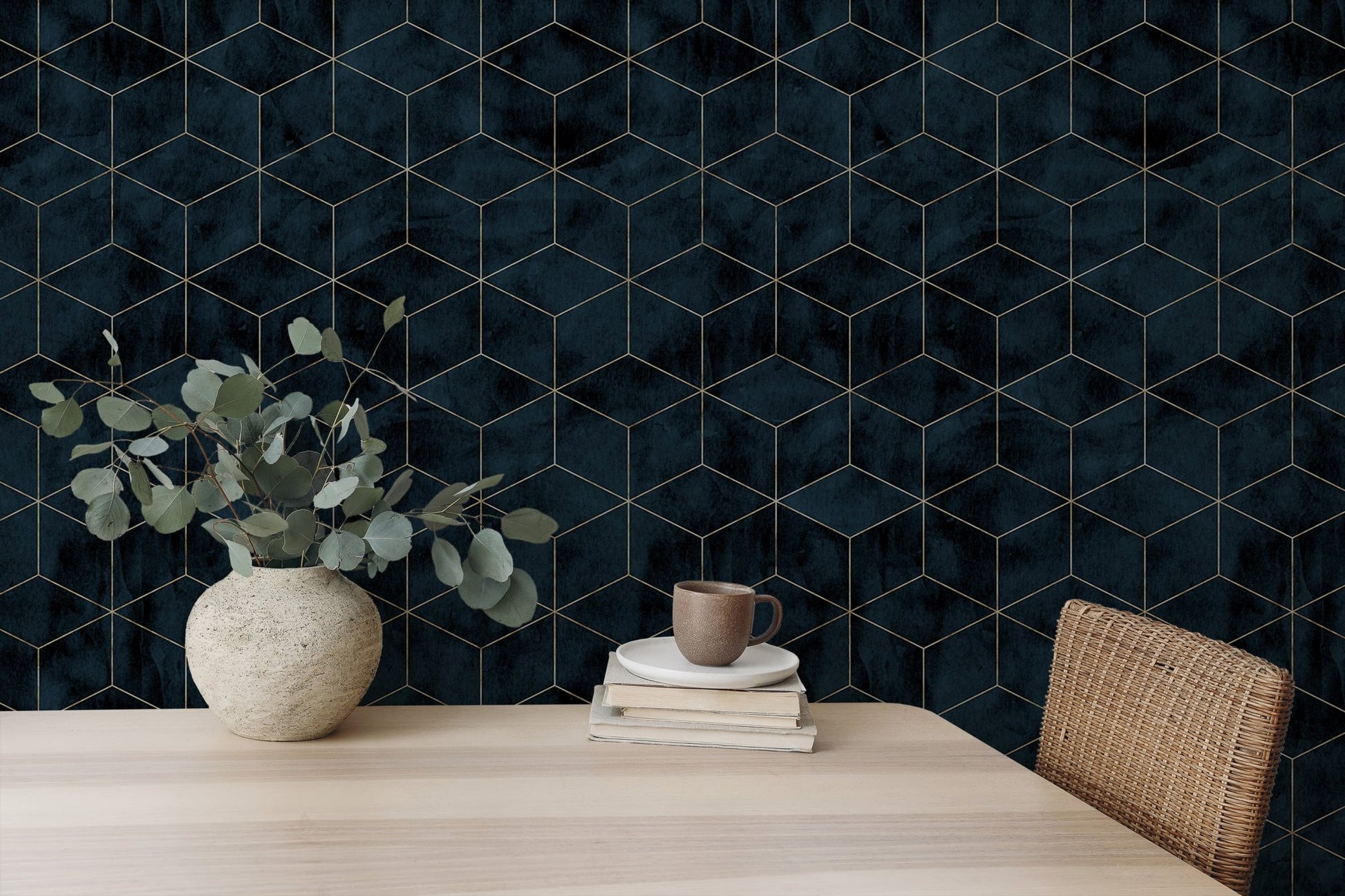 Geometric navy wallpaper paired with a wooden dining table and green plants.