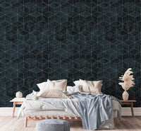 Art Deco geometric wallpaper as a backdrop for a light-colored bed frame.