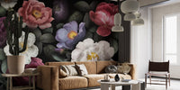Dark botanical wall mural in living room with tan leather couch.