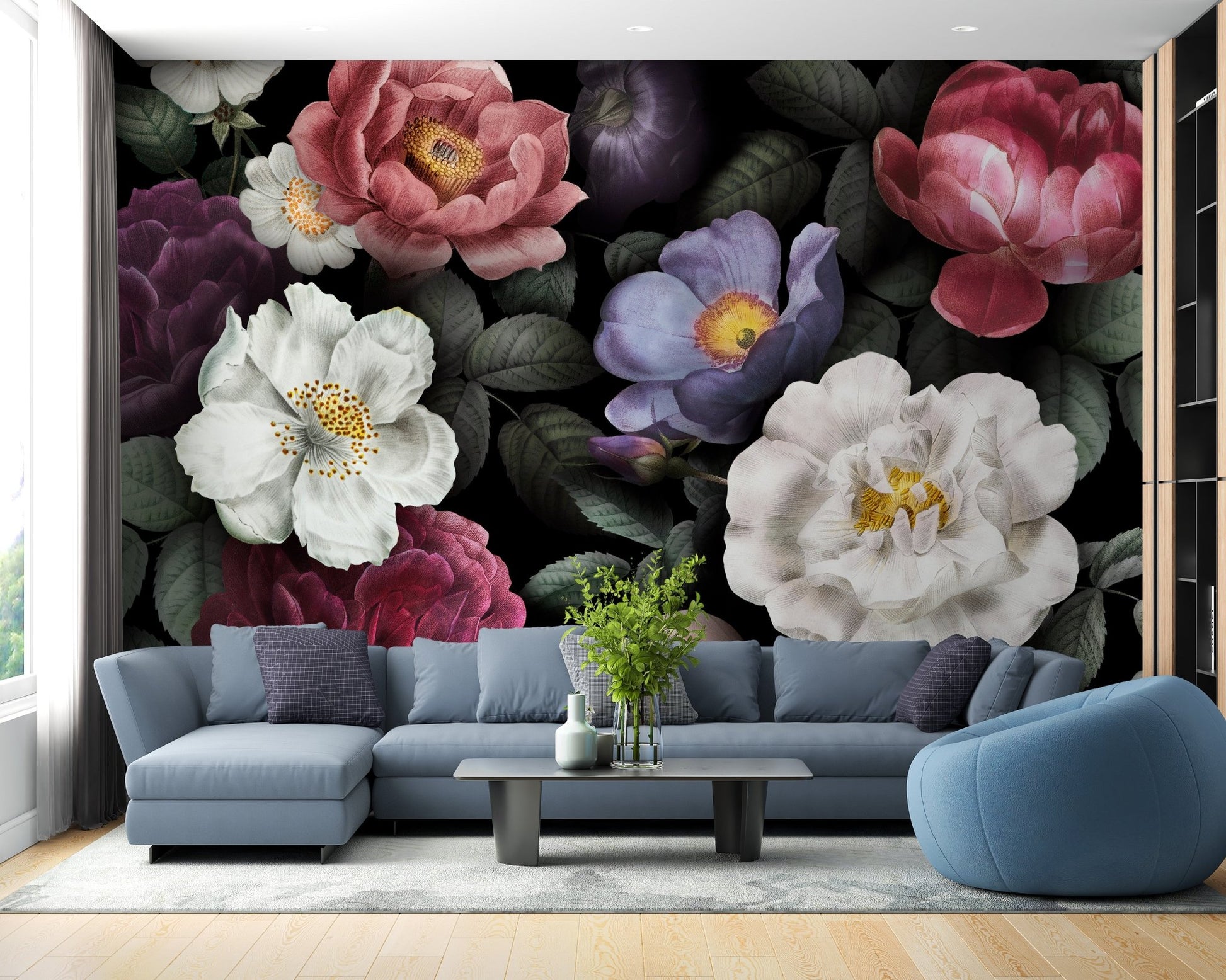 Blue sectional sofa paired with dark botanical wall mural in contemporary home.