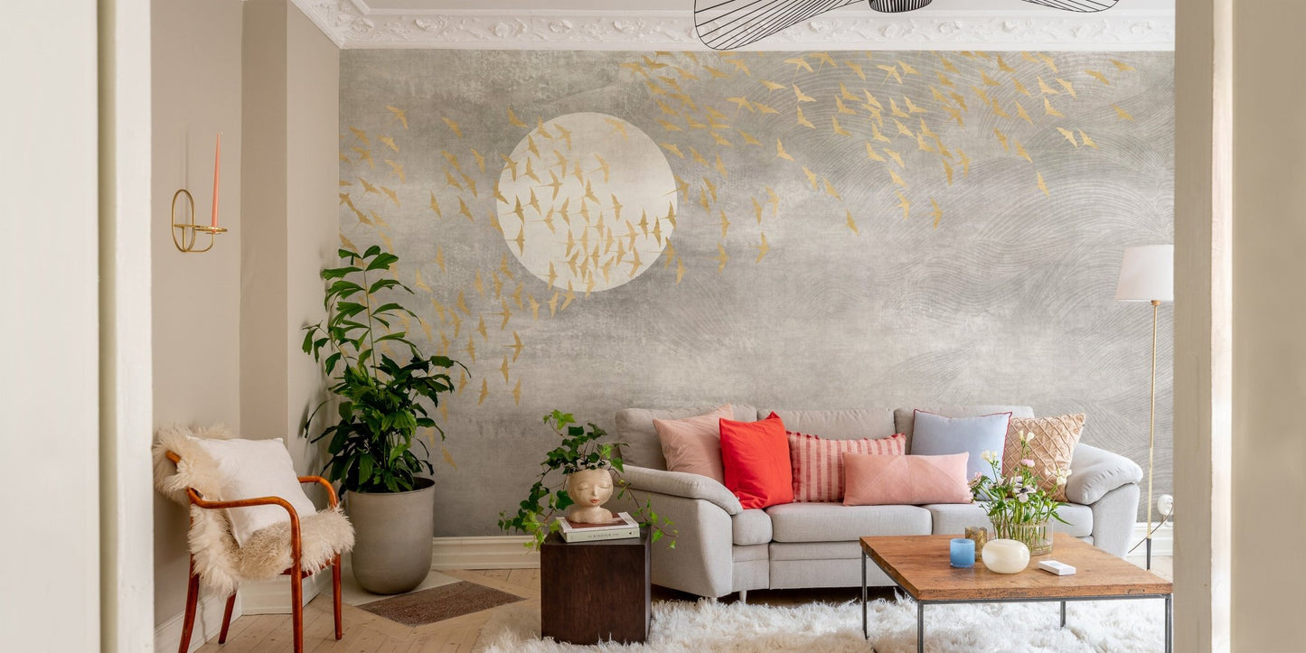Beige sofa in living room with grey concrete style wall mural and flying birds.