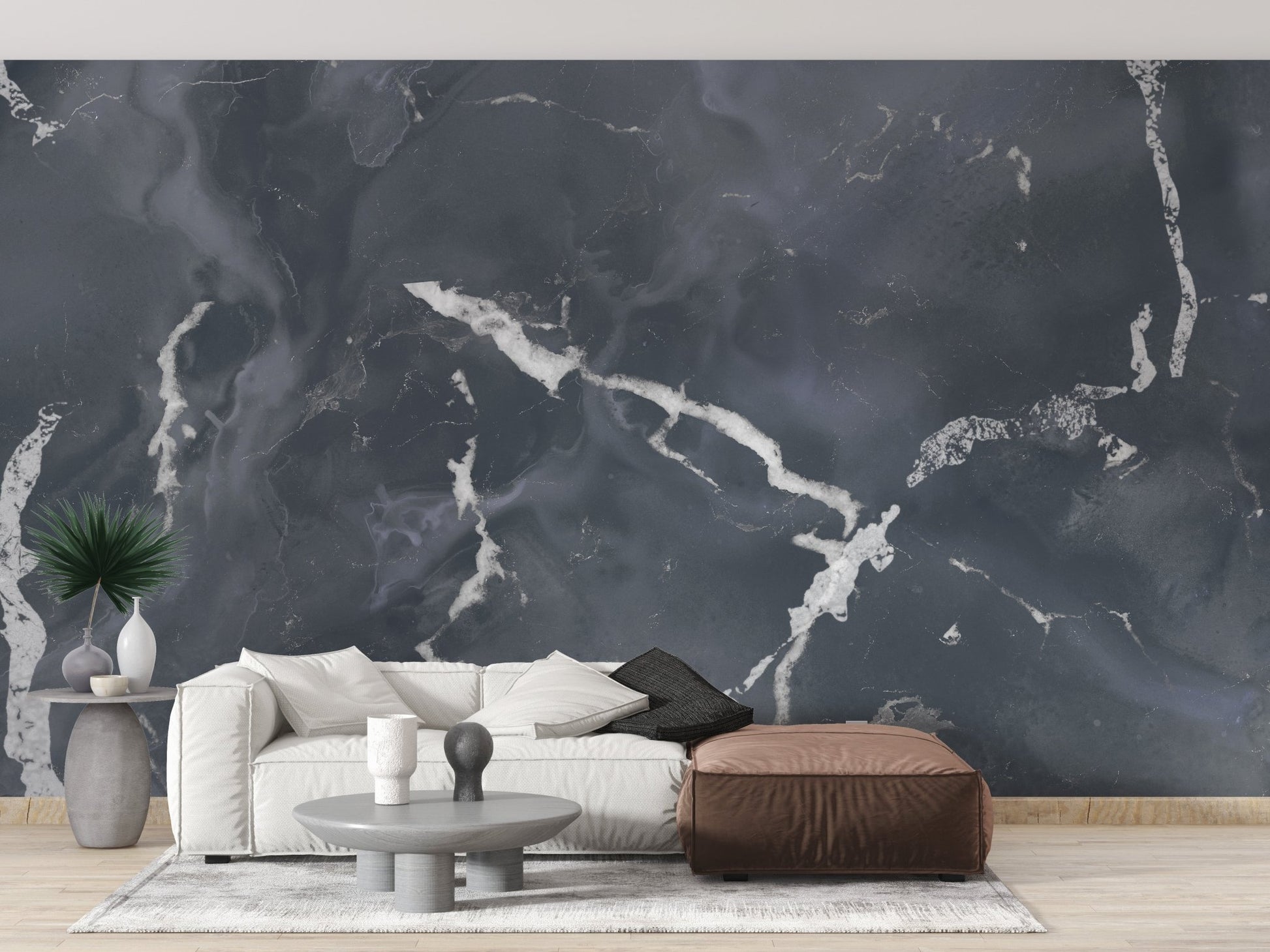Living room with leather seating and textured granite wall mural.