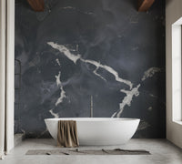 Modern bathroom setting with dark marble effect mural behind bathtub.