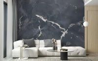 White sectional sofa against a dark gray granite texture wall mural.