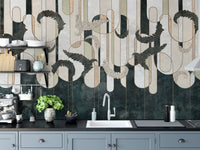 Kitchen wall mural with geometric shapes placed behind a sink and grey cabinets.