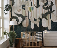 Nursery wall mural with dark green abstract art and a wooden crib.