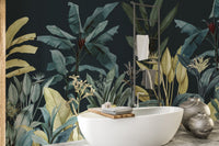 Dark green foliage wall mural behind a white porcelain bathtub in a modern bathroom.