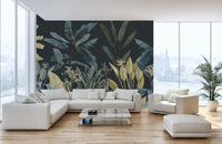 Tropical oasis leaf wall mural behind a large white corner couch and wooden floor.