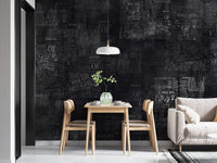 Artistic newspaper textured wall mural in a small dining nook.