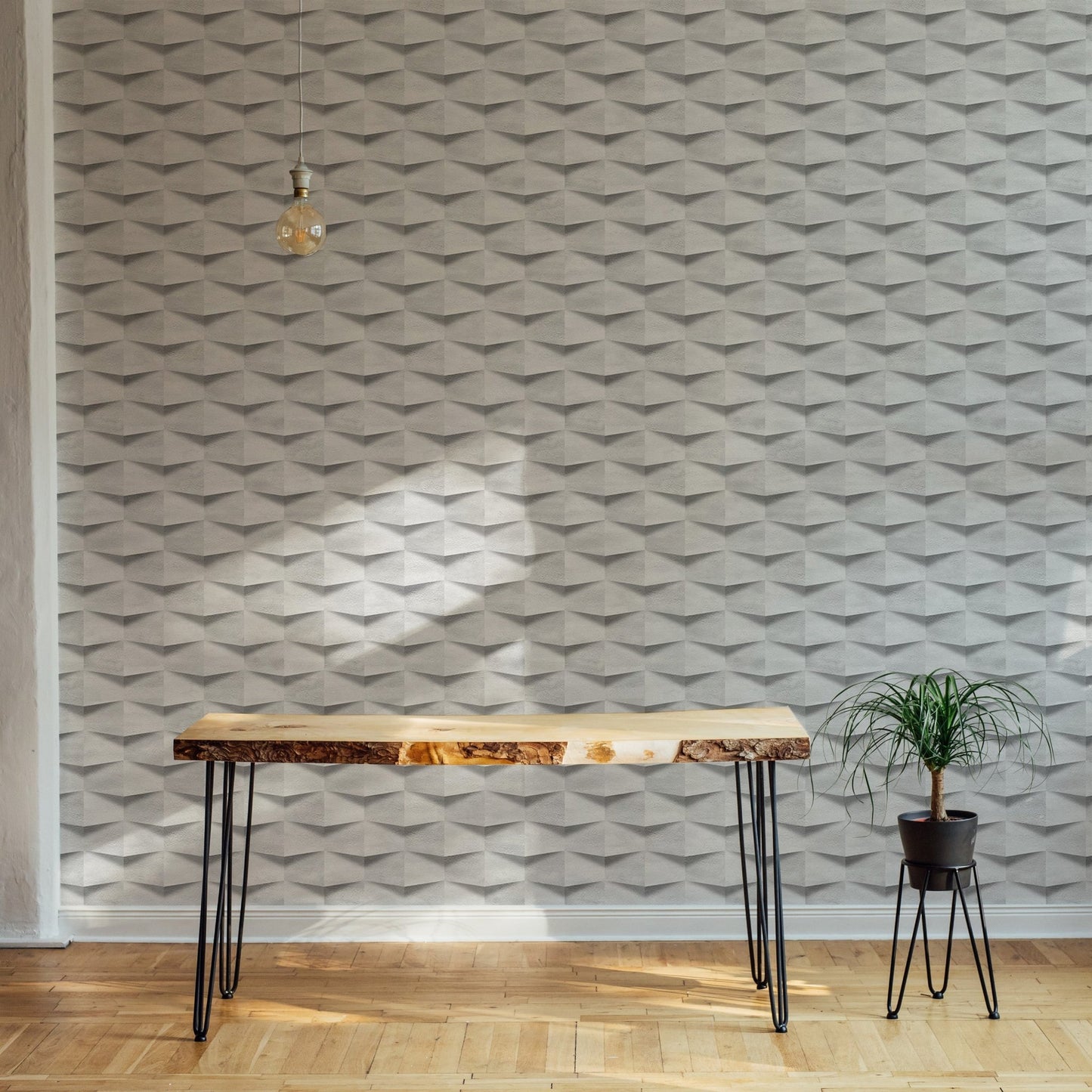 Minimalist office with a wooden desk against a white abstract 3D wallpaper.