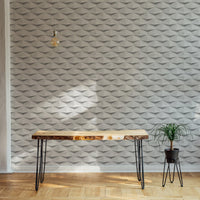 Minimalist office with a wooden desk against a white abstract 3D wallpaper.