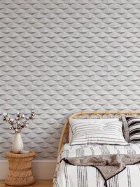 Architectural 3D wallpaper behind a single bed with striped linens and brown throw.