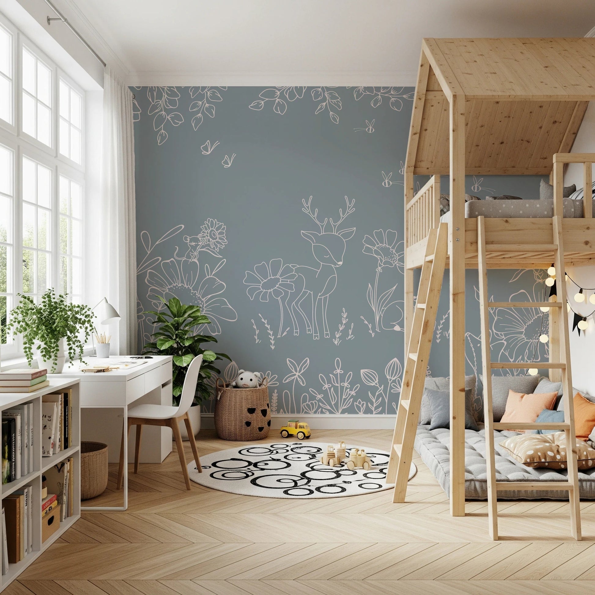 Blue wall mural with white deer sketches in a kids room with a wooden bunk bed.