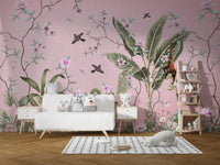Monkey and hummingbird embellish wall mural in a kids playroom with white storage units.