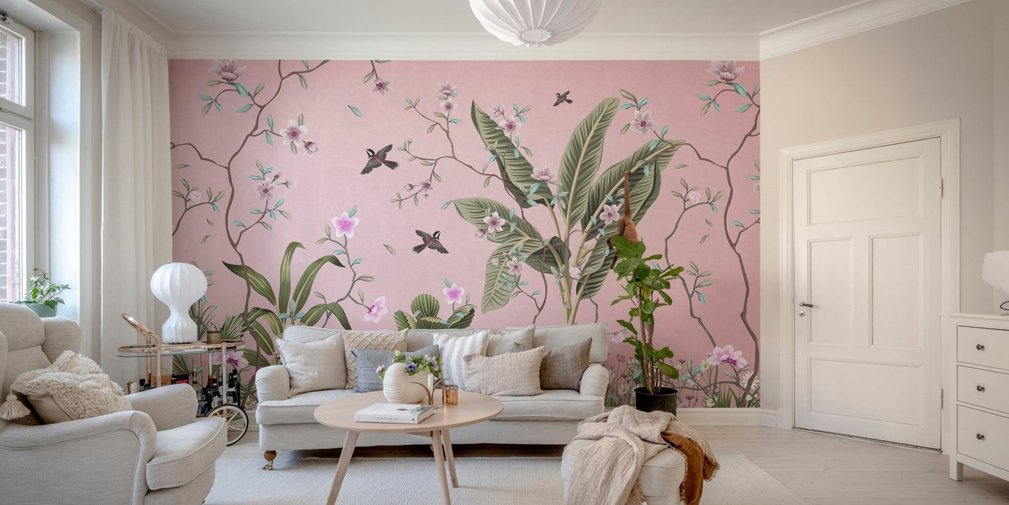 Pink floral wall mural behind a grey sofa in a minimalist living room area.