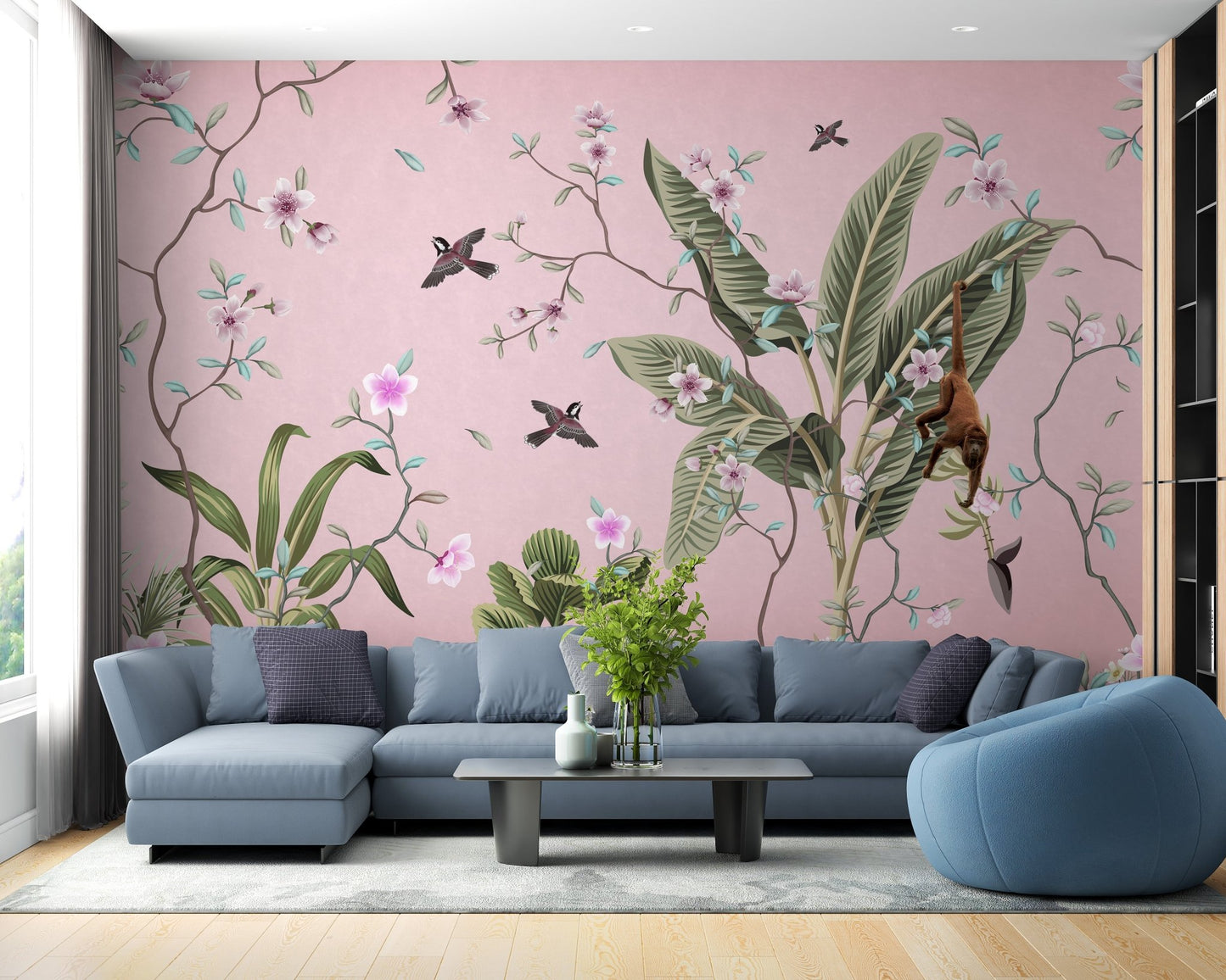 Tropical floral wall mural with a blue sectional sofa and light wood flooring.