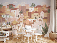 Children’s seating area with a desert-themed wall mural and white wooden chairs.