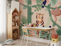Tiger and sloth forest wall mural behind a study desk and white chair.



