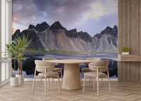 Stylish dining space with a dark-toned mountain landscape wall mural.
