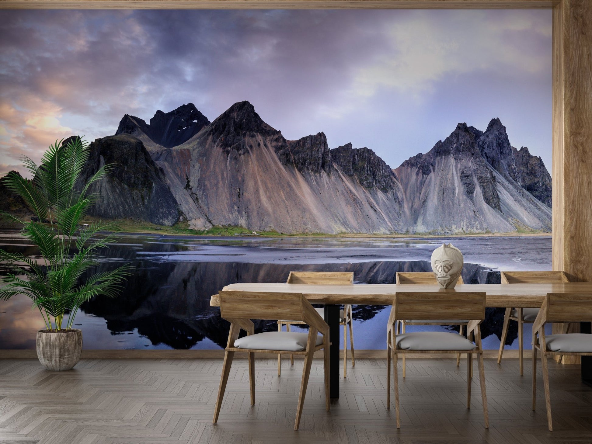 Dining table setup against a striking mountain range wall mural.