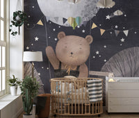 Bear with balloons flying in pastel sky
