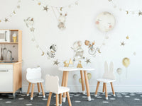 Decorative mural with playful animals under a starlit sky
