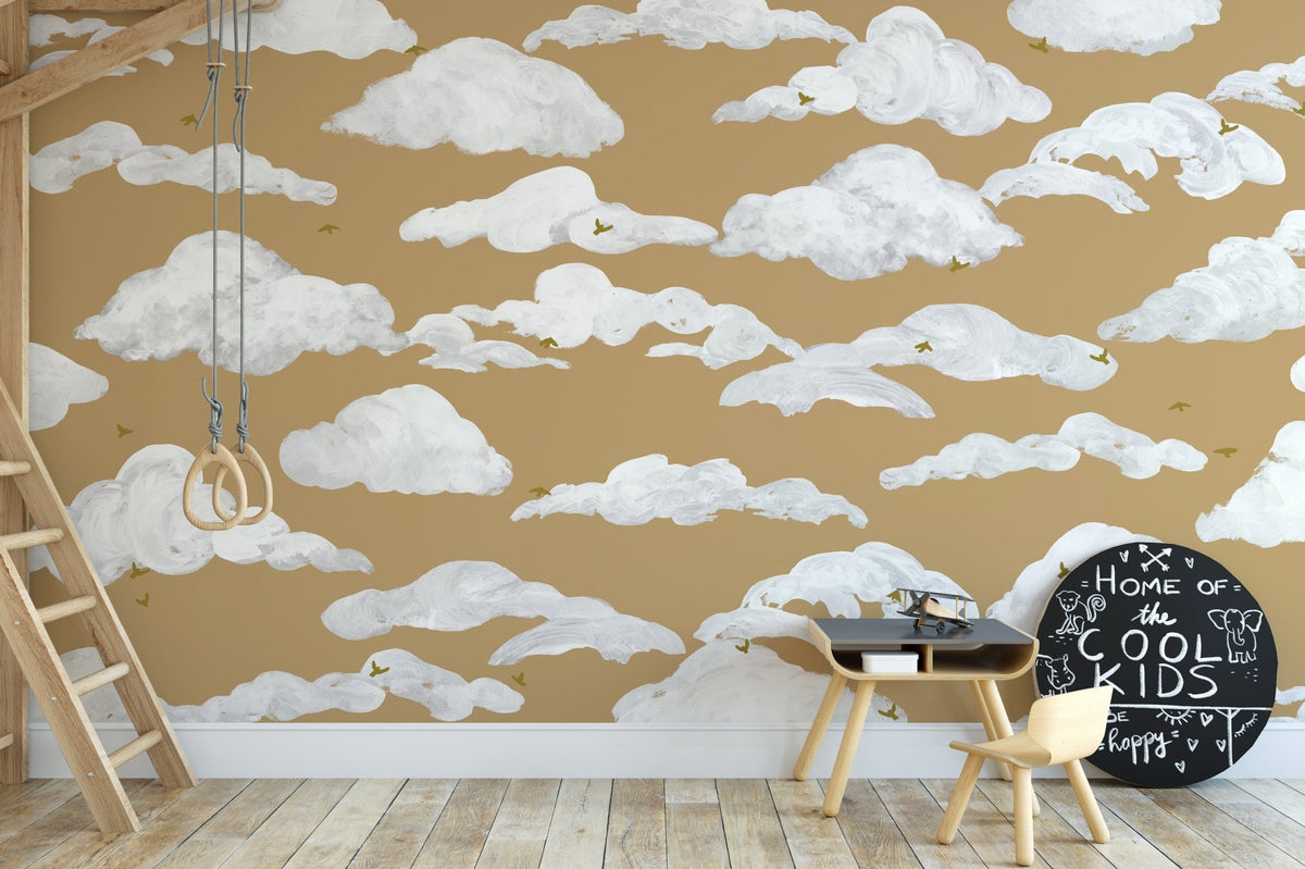 Dreamy sky birds wall mural with white clouds on mustard wallpaper.