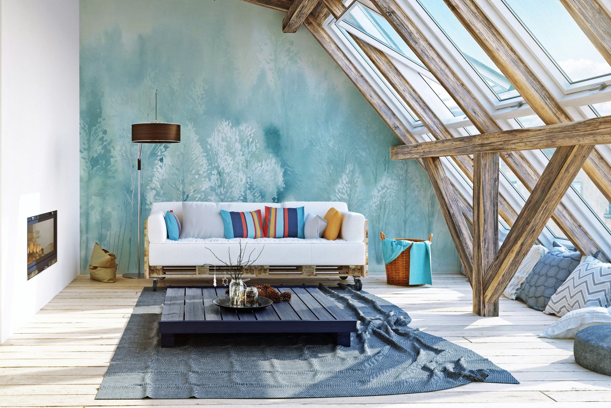 Attic living space with a white couch and textured blue tree wall mural under skylights.
