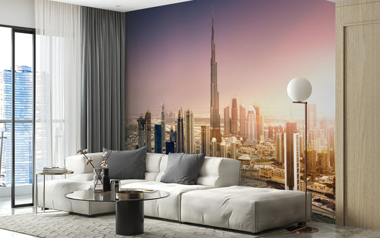 Cityscape wall mural featuring a sunset skyline behind a white sectional sofa.