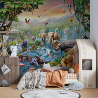 Realistic animal wall mural behind a wooden toddler bed and orange bedding.