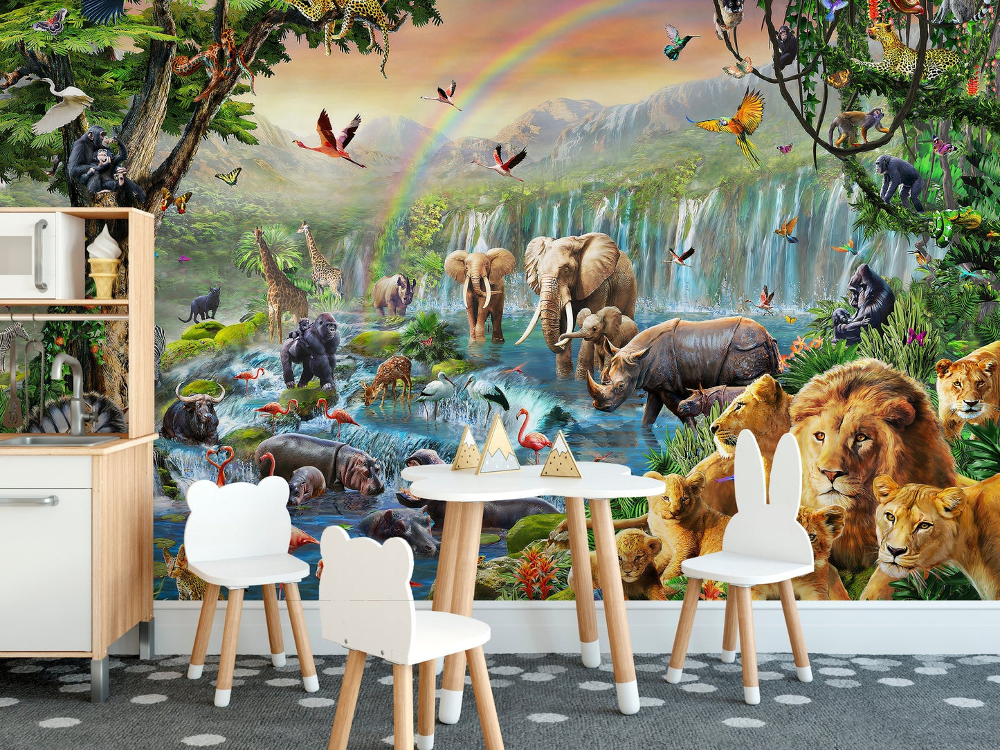 Jungle animal wall mural behind a white table and chairs set in children dining area.