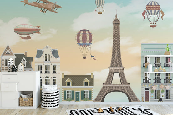 Nursery wall mural showing Parisian street scene and tan Eiffel Tower.