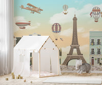 Blue sky and city skyline wall mural for bright nursery interior.