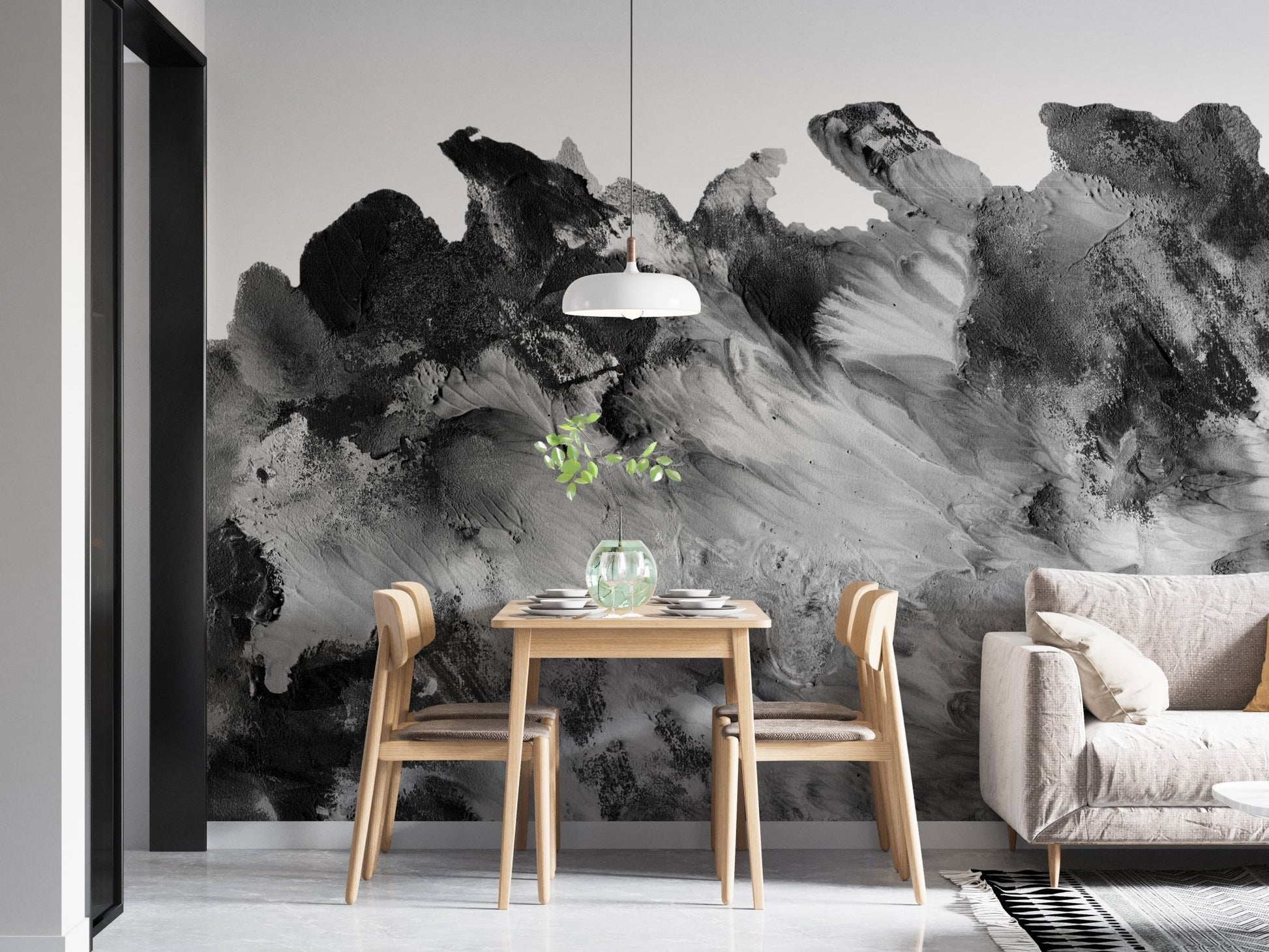 Small dining space with a white pendant light and abstract gray wall mural.