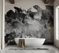 Modern bathroom with a white freestanding tub and a dark abstract grayscale wall mural.