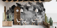 Industrial cafe interior with wooden tables and a rustic effect wall mural.