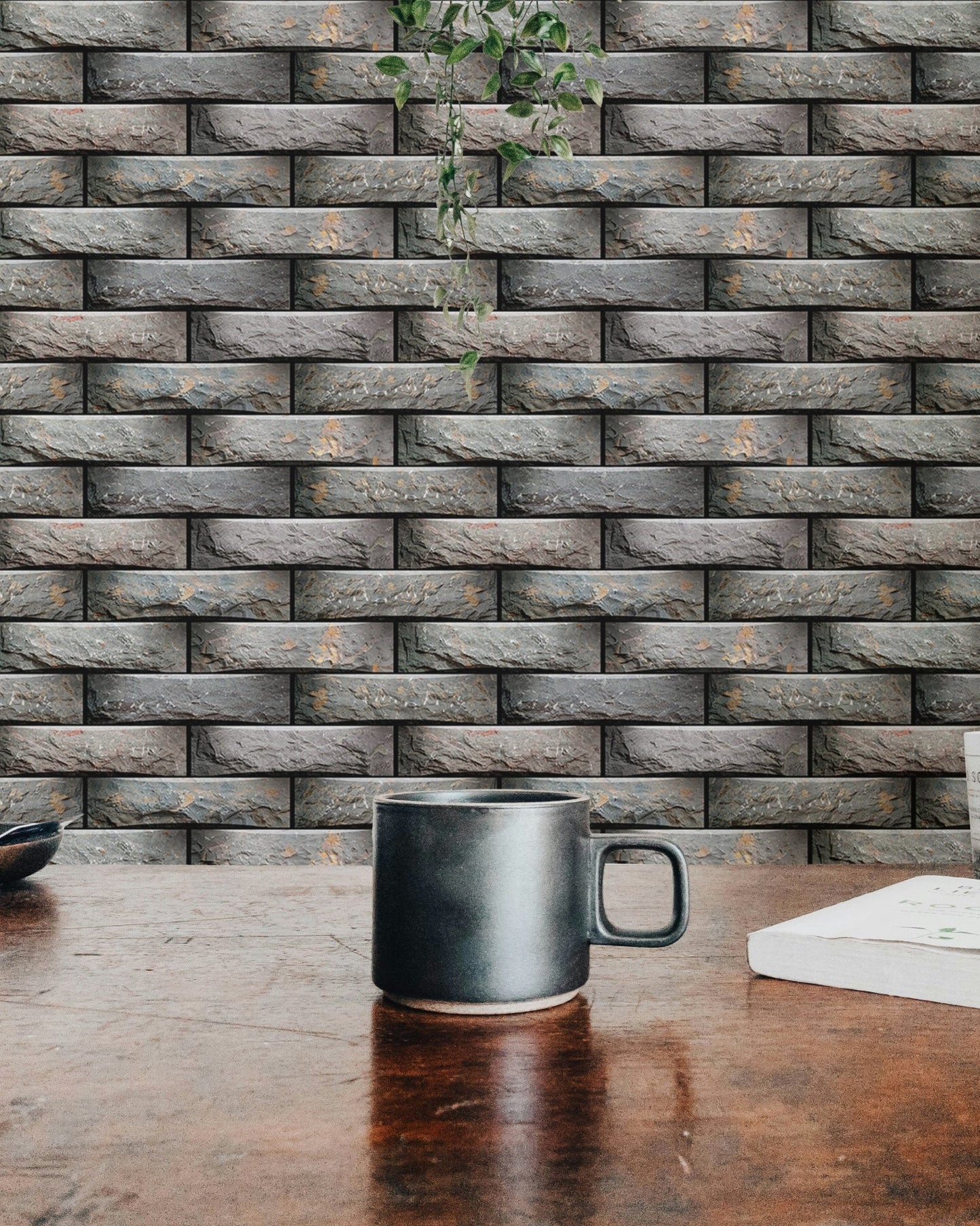 Close view of a coffee mug on a table with grey geometric modules wallpaper.