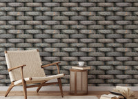 Reading nook with neutral stone pattern wallpaper and a wooden armchair.