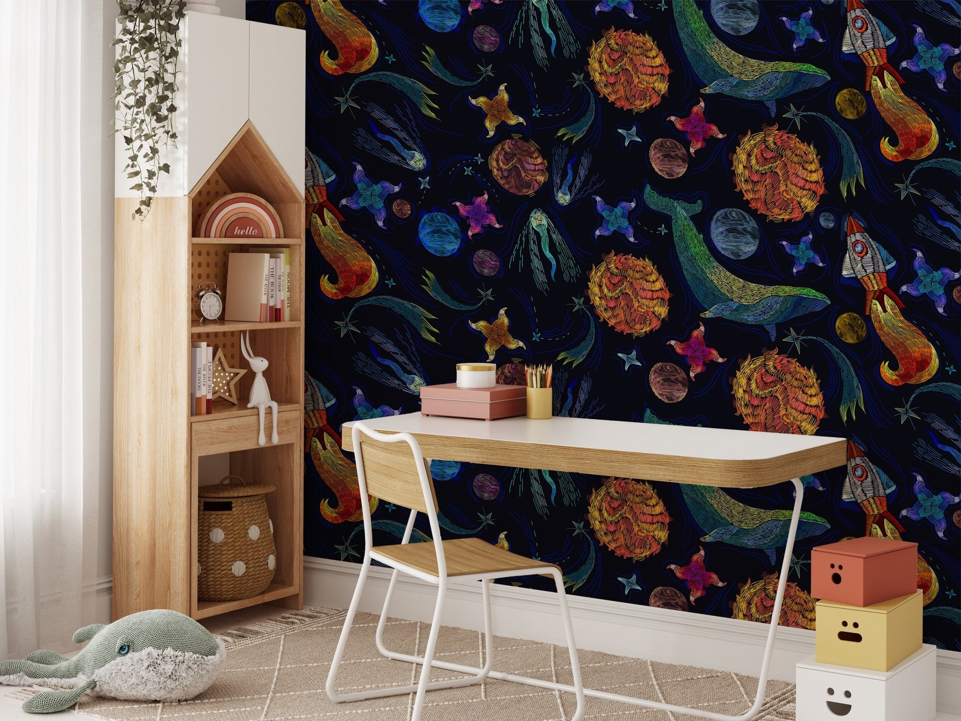 Dark blue wallpaper with embroidered star motifs in a study room with a wooden desk.