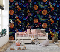 Space adventure wallpaper in a kids' bedroom with a white daybed and pink pillows.