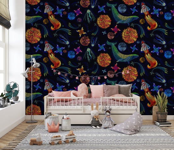 Space adventure wallpaper in a kids' bedroom with a white daybed and pink pillows.