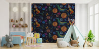 Navy blue space adventure wallpaper with colorful cosmic shapes in a modern kids bedroom.