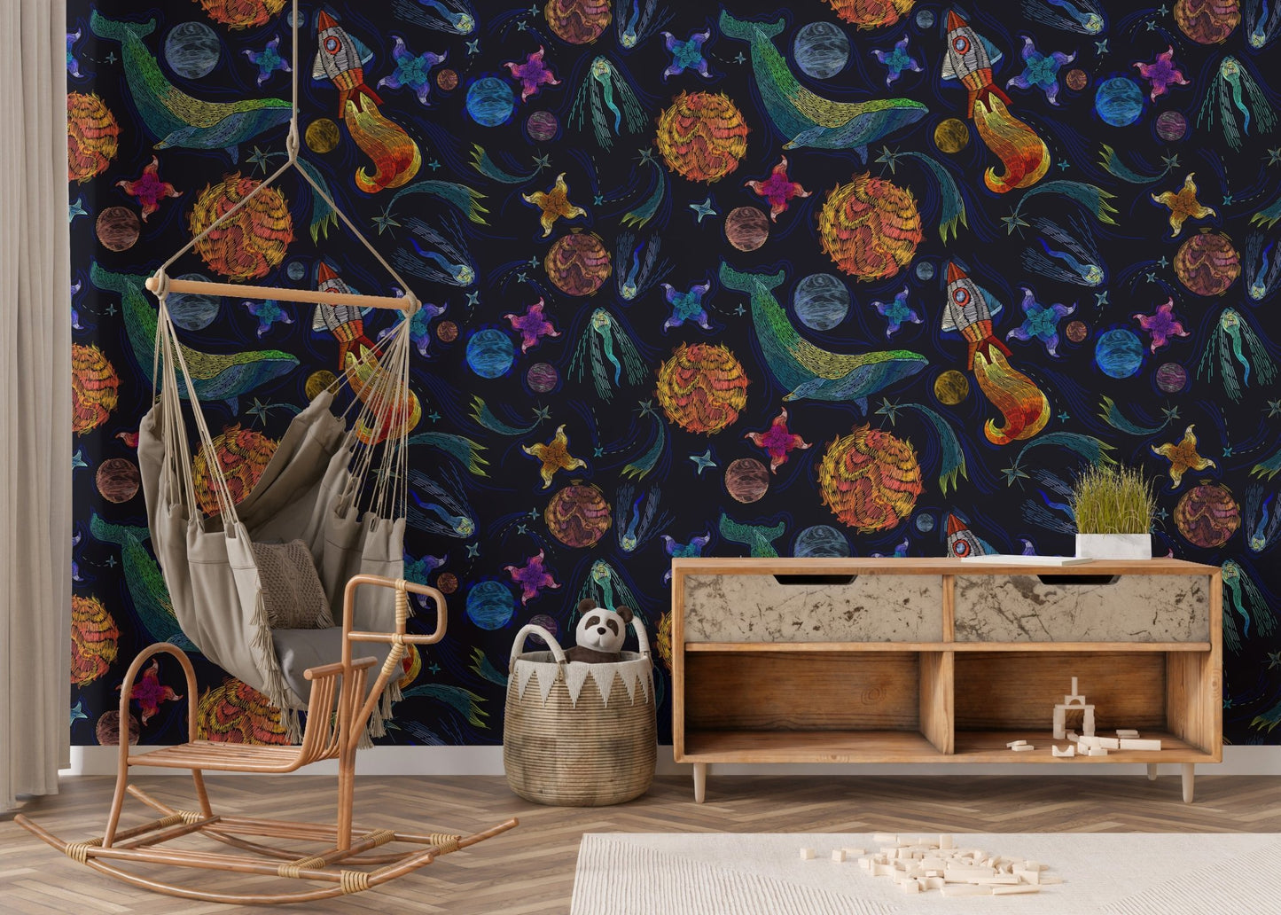 Embroidery inspired space adventure wallpaper in a room with a wooden rocking chair.