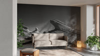 Grey rock formation wall mural behind a beige couch in a sunlit lounge