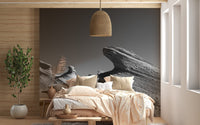 Neutral rock landscape mural in a bedroom with beige linens and wood walls