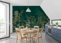 Dark green botanical wall mural in a dining area with a round wooden table