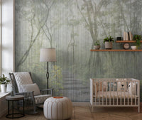 Nursery room featuring a misty forest wall mural with a white crib and grey chair.