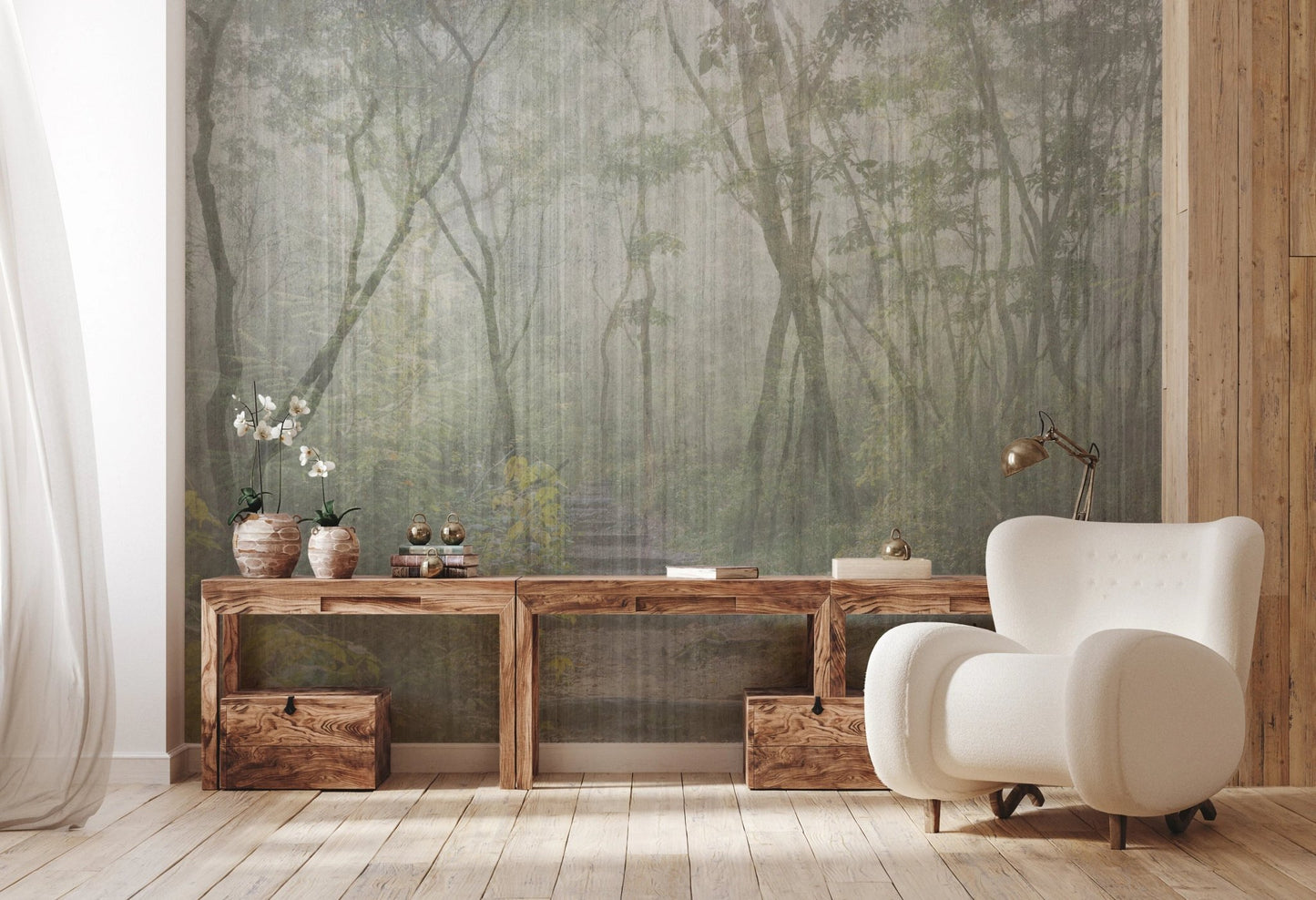 Forest scenery wall mural with a rustic wooden console table and white armchair.